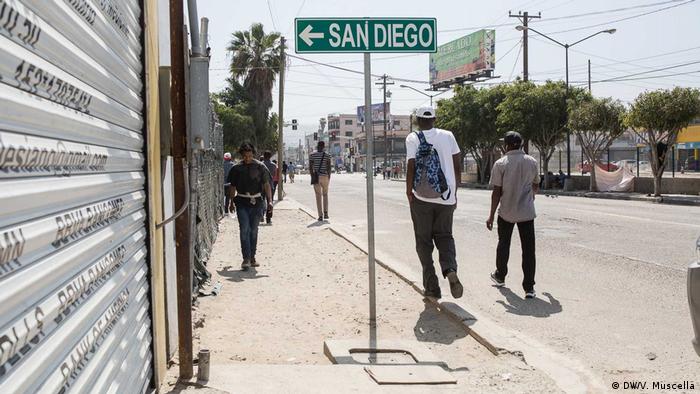 A street sign in Tijuana, Mexico, indicates the direction of San Diego, California, in the United States
