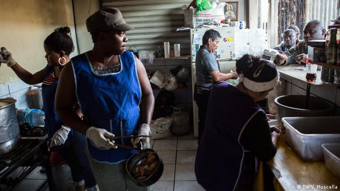 Haitian migrants serve food from the kitchen of a restaurant in Avenida Ocampo in central Tijuana, Mexico