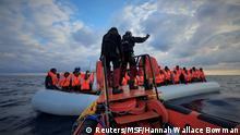 Rescuers help migrants on a raft at sea (Reuters/MSF/Hannah Wallace Bowman)